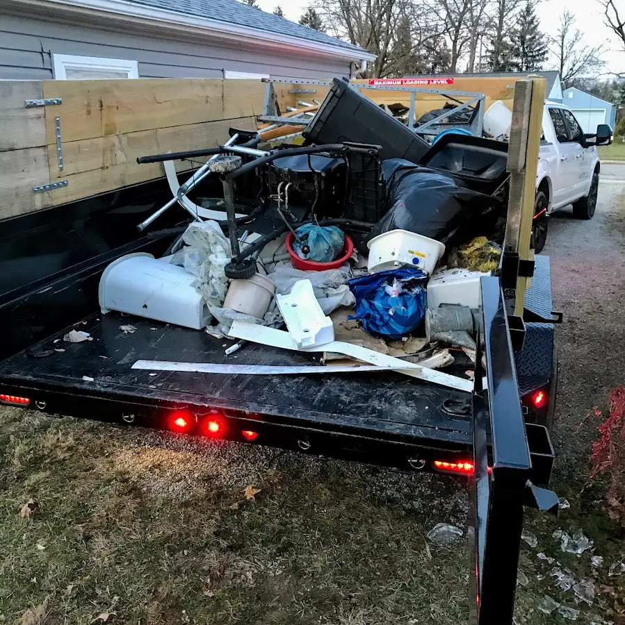 Roll-off dumpster delivered to a residential driveway in Riga